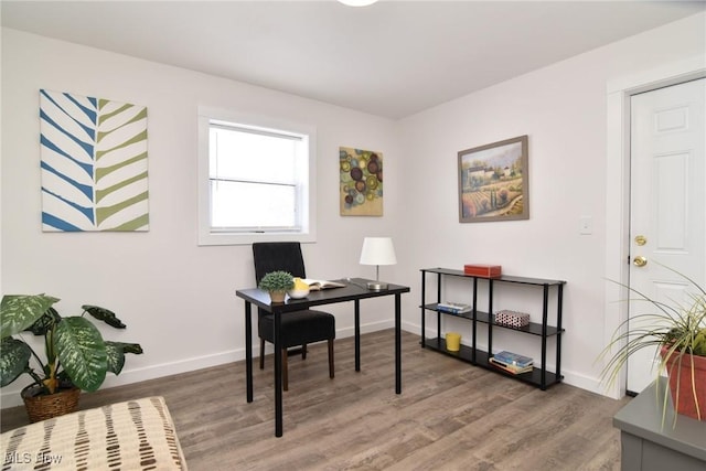 home office featuring wood finished floors and baseboards