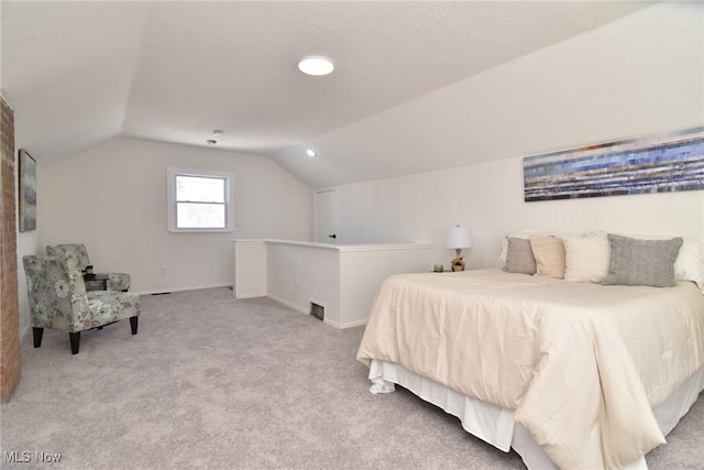 bedroom featuring baseboards, carpet, and vaulted ceiling