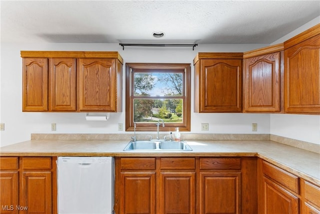 kitchen with sink, a textured ceiling, and dishwasher