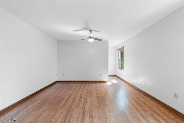 empty room featuring ceiling fan and light hardwood / wood-style floors