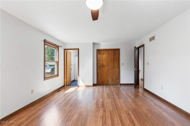 unfurnished bedroom featuring ceiling fan and light wood-type flooring