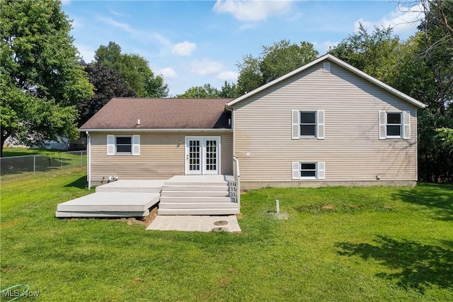 back of house with a wooden deck, a yard, and french doors