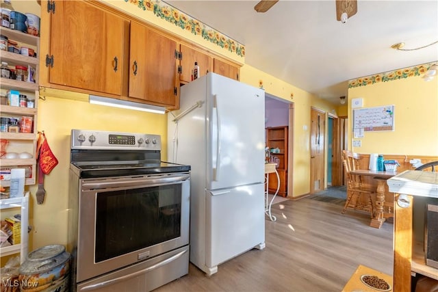 kitchen with white refrigerator, ceiling fan, stainless steel electric stove, and light wood-type flooring