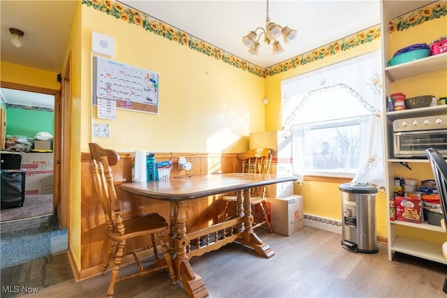 dining room featuring hardwood / wood-style flooring and a chandelier