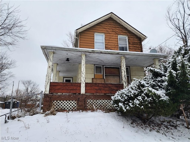 view of front facade with a porch and fence