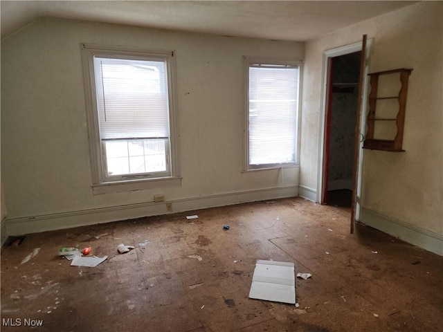 unfurnished bedroom featuring lofted ceiling