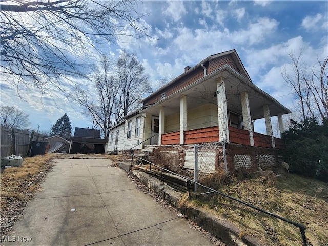 view of property exterior featuring a chimney and fence