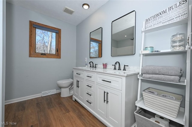 bathroom with vanity, hardwood / wood-style floors, and toilet