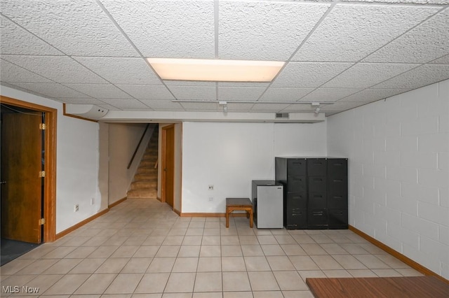 basement with stainless steel refrigerator