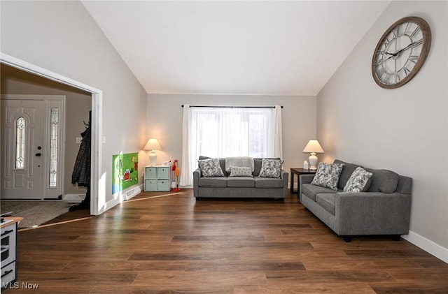 living room with dark wood-type flooring and vaulted ceiling