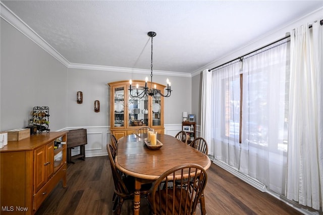 dining space with a notable chandelier, crown molding, and dark wood-type flooring