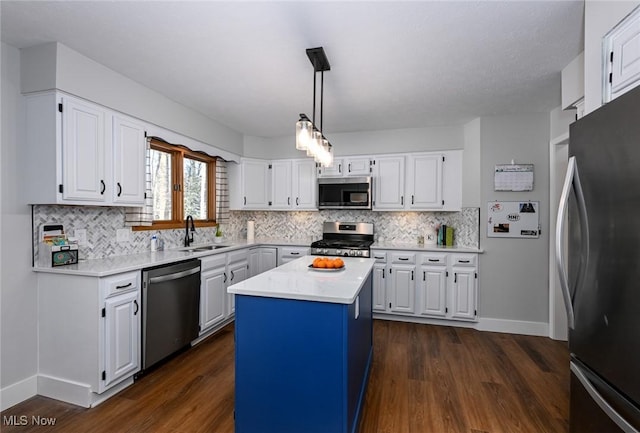 kitchen with white cabinetry, a kitchen island, dark hardwood / wood-style floors, and appliances with stainless steel finishes