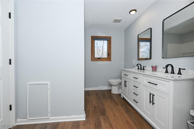 bathroom with vanity, hardwood / wood-style floors, and toilet