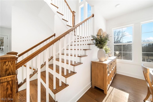 stairway with hardwood / wood-style floors