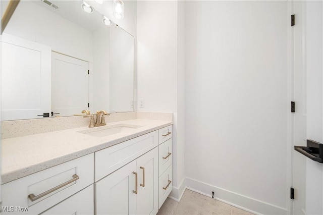 bathroom featuring tile patterned flooring and vanity