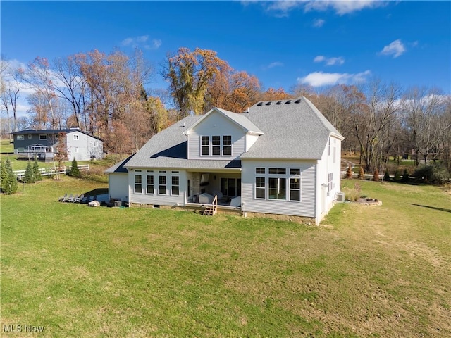 back of property featuring a lawn