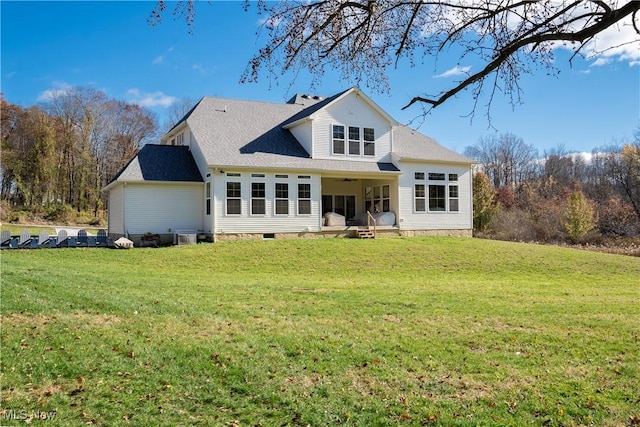 rear view of property with a lawn