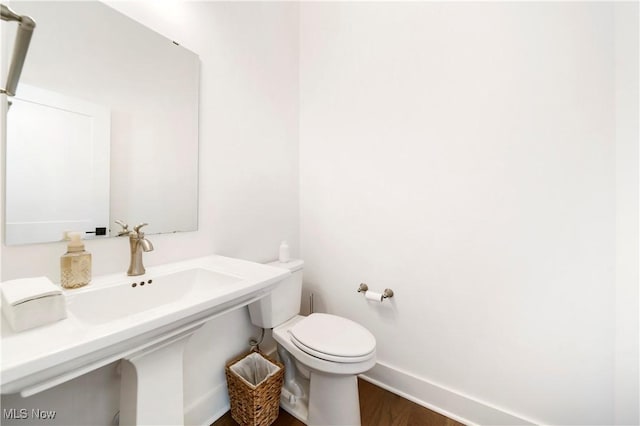 bathroom with wood-type flooring and toilet