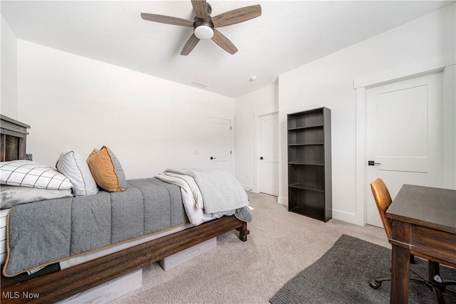 bedroom featuring light colored carpet and ceiling fan