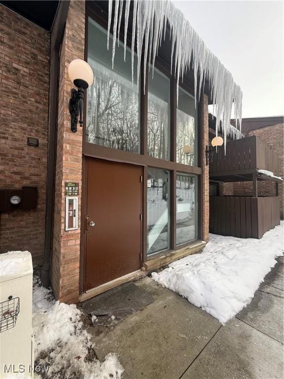 view of snow covered property entrance