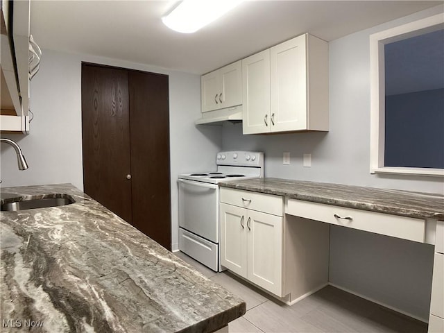 kitchen with white electric stove, sink, light tile patterned floors, and white cabinets