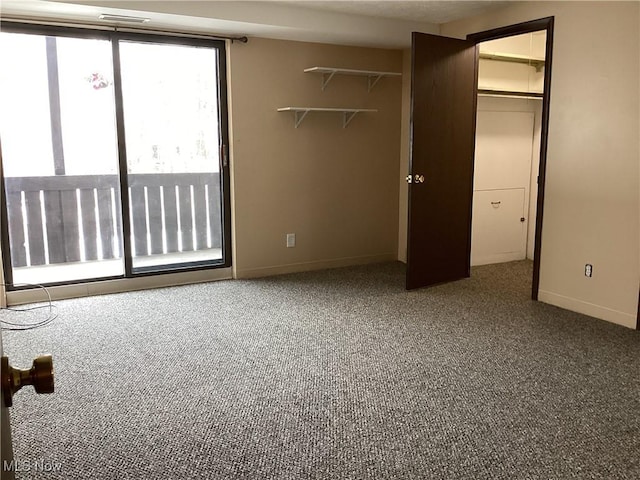 unfurnished bedroom featuring carpet flooring and a spacious closet