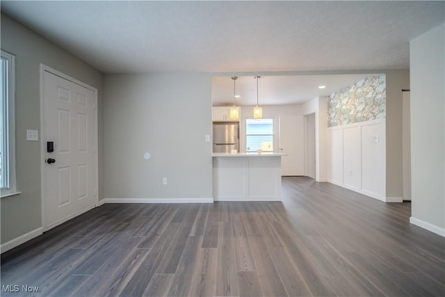 unfurnished living room with dark hardwood / wood-style floors