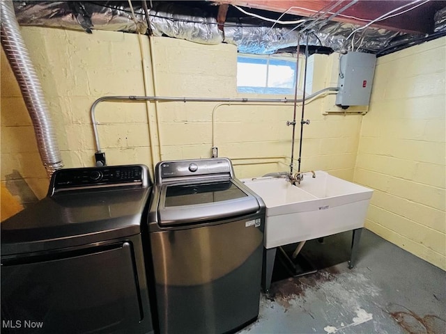 laundry area with electric panel, sink, and washer and dryer