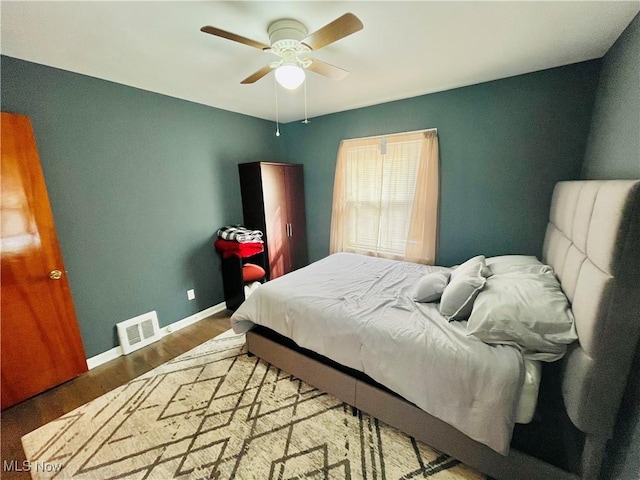 bedroom with hardwood / wood-style flooring and ceiling fan