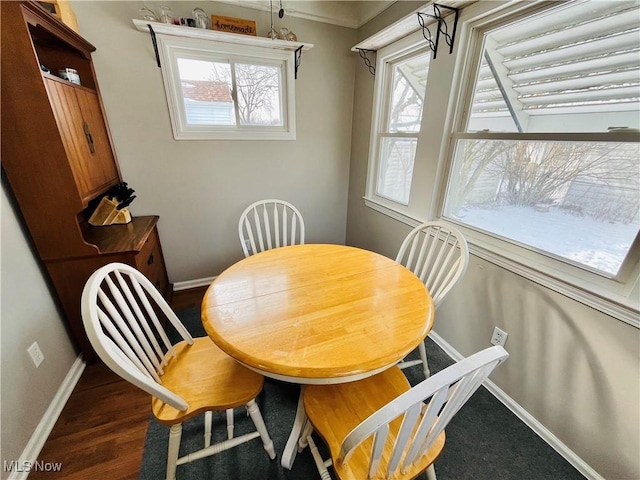 dining space featuring crown molding and dark hardwood / wood-style floors