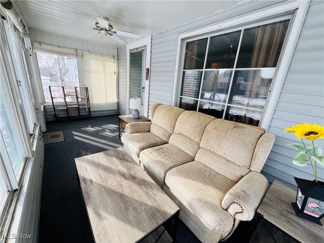 sunroom featuring ceiling fan