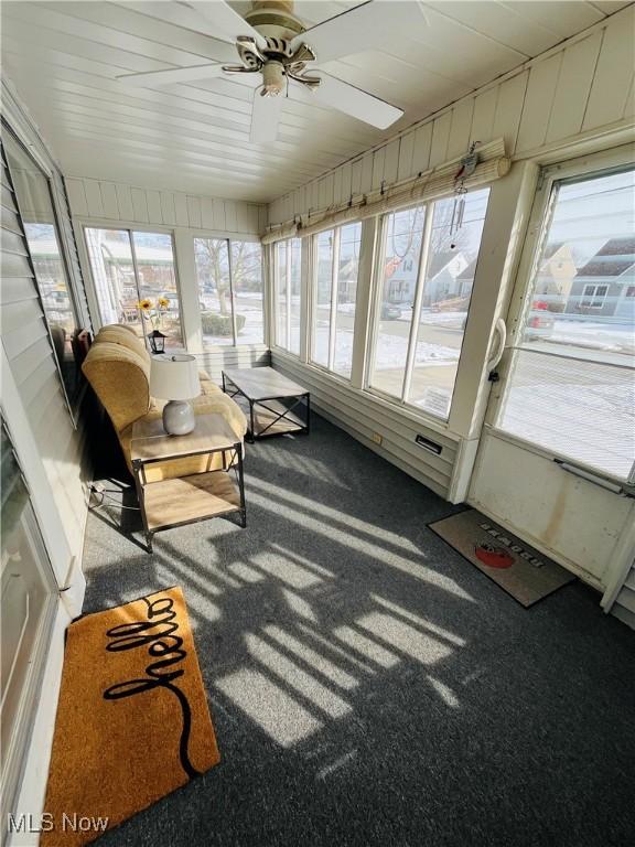 sunroom / solarium with ceiling fan and a healthy amount of sunlight