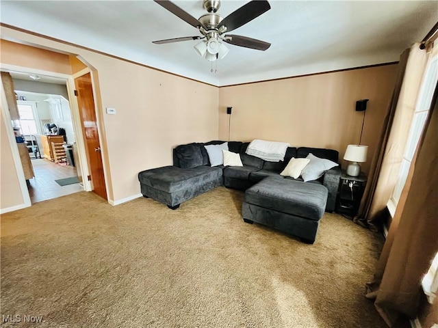 carpeted living room featuring ceiling fan