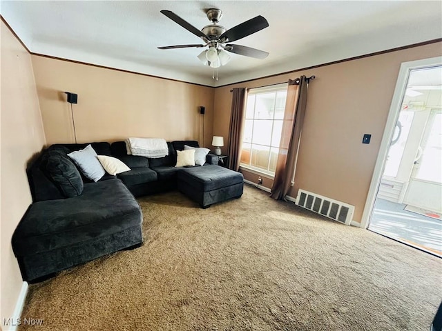 living room with ceiling fan and light colored carpet