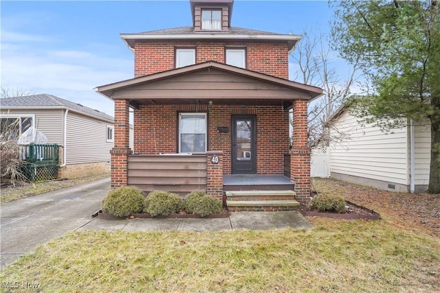 bungalow-style house with covered porch and a front lawn