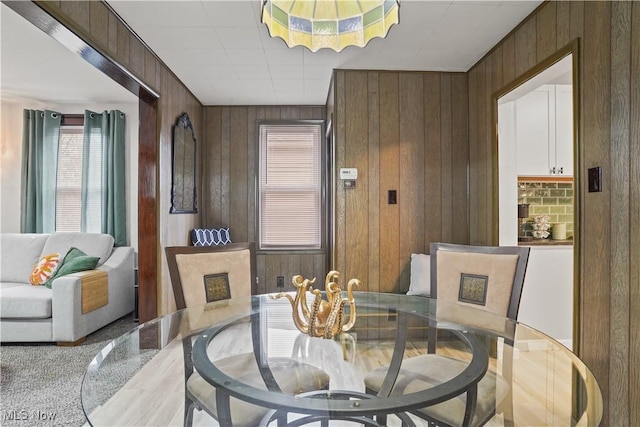 dining room featuring wood walls