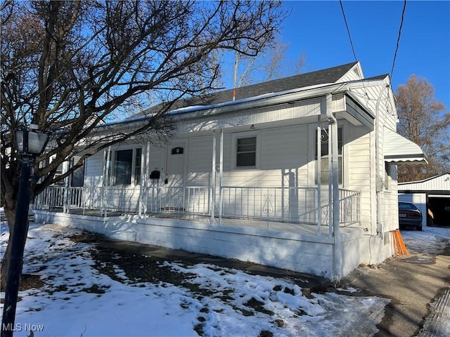 bungalow featuring a garage and covered porch