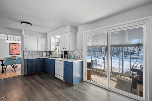 kitchen with dark wood-type flooring, sink, white cabinetry, white dishwasher, and backsplash