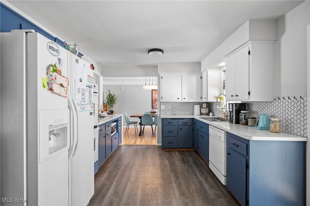 kitchen featuring dark hardwood / wood-style floors, white cabinetry, sink, decorative backsplash, and white appliances