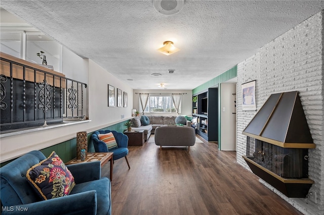 living room featuring hardwood / wood-style flooring and a textured ceiling