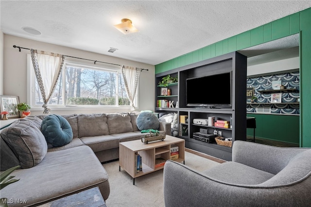 carpeted living room featuring a textured ceiling