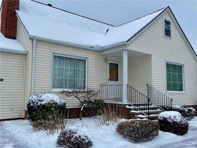 view of snow covered property entrance