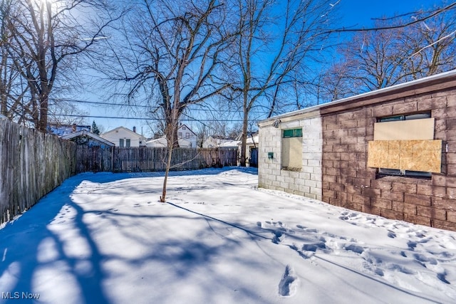 view of yard layered in snow