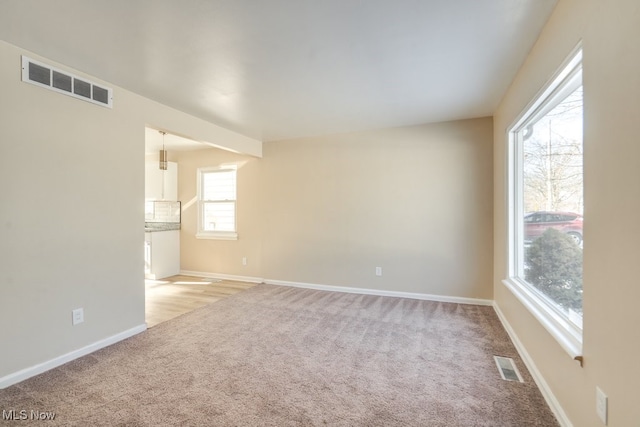 empty room featuring light carpet