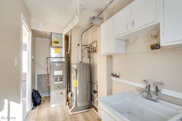 utility room with sink and water heater