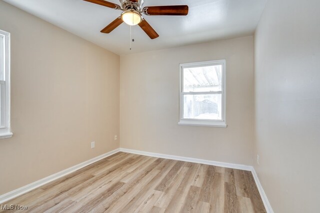 empty room with light hardwood / wood-style flooring and ceiling fan