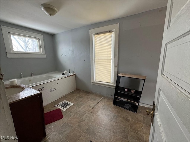 bathroom featuring vanity and a tub