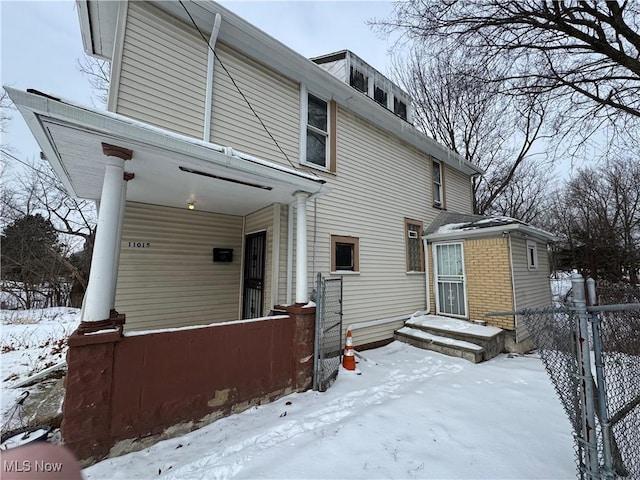 view of snow covered rear of property