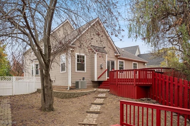 rear view of property with central AC unit and a deck