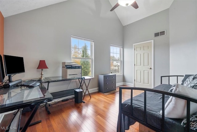 bedroom with high vaulted ceiling, light wood-type flooring, and ceiling fan